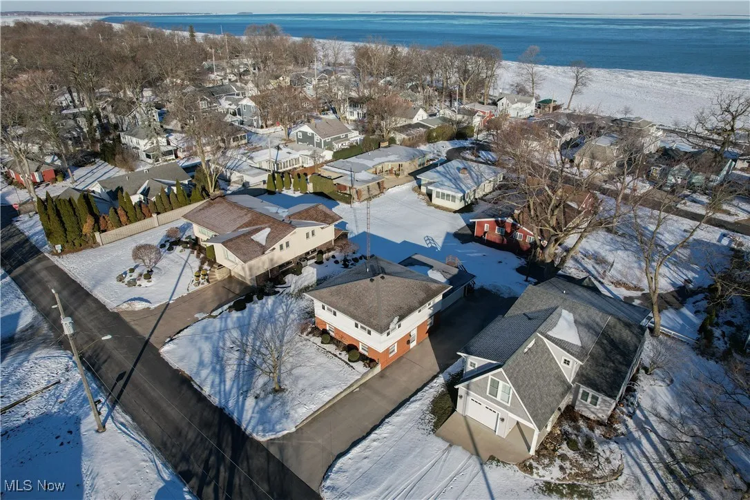 Snowy aerial view with a water view