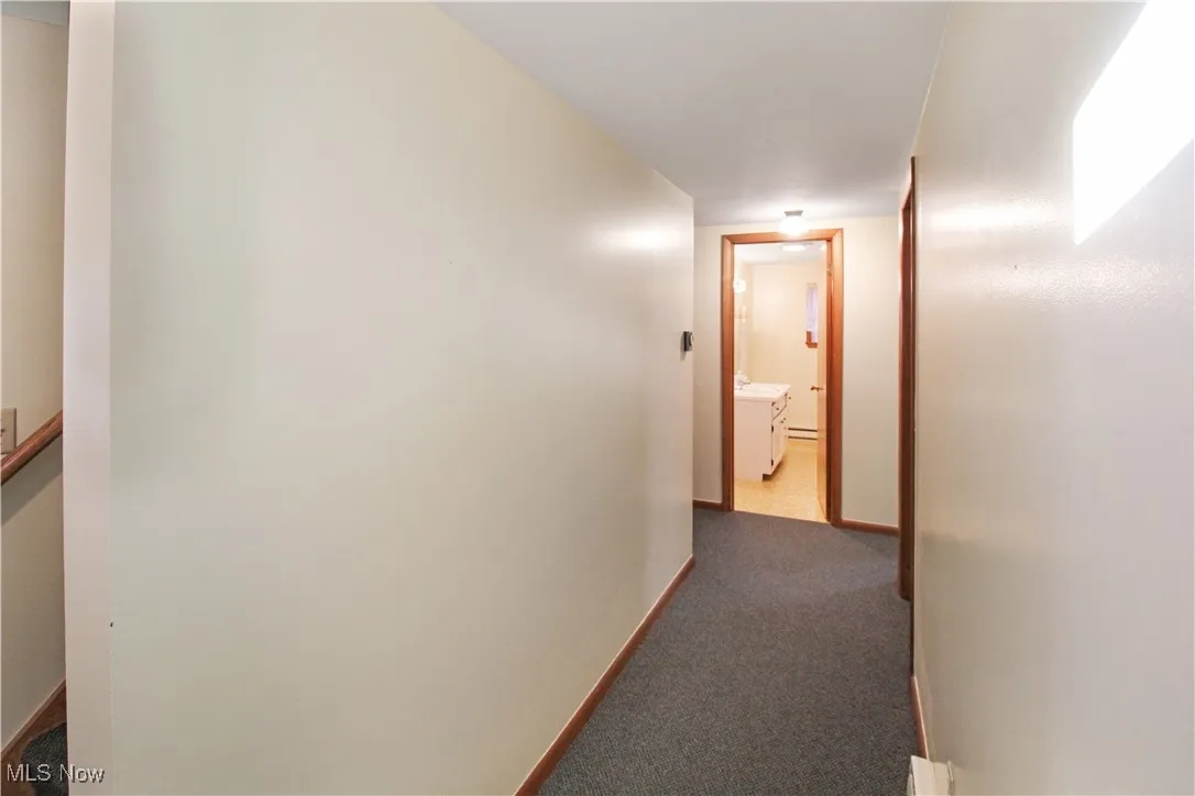 Corridor featuring carpet floors