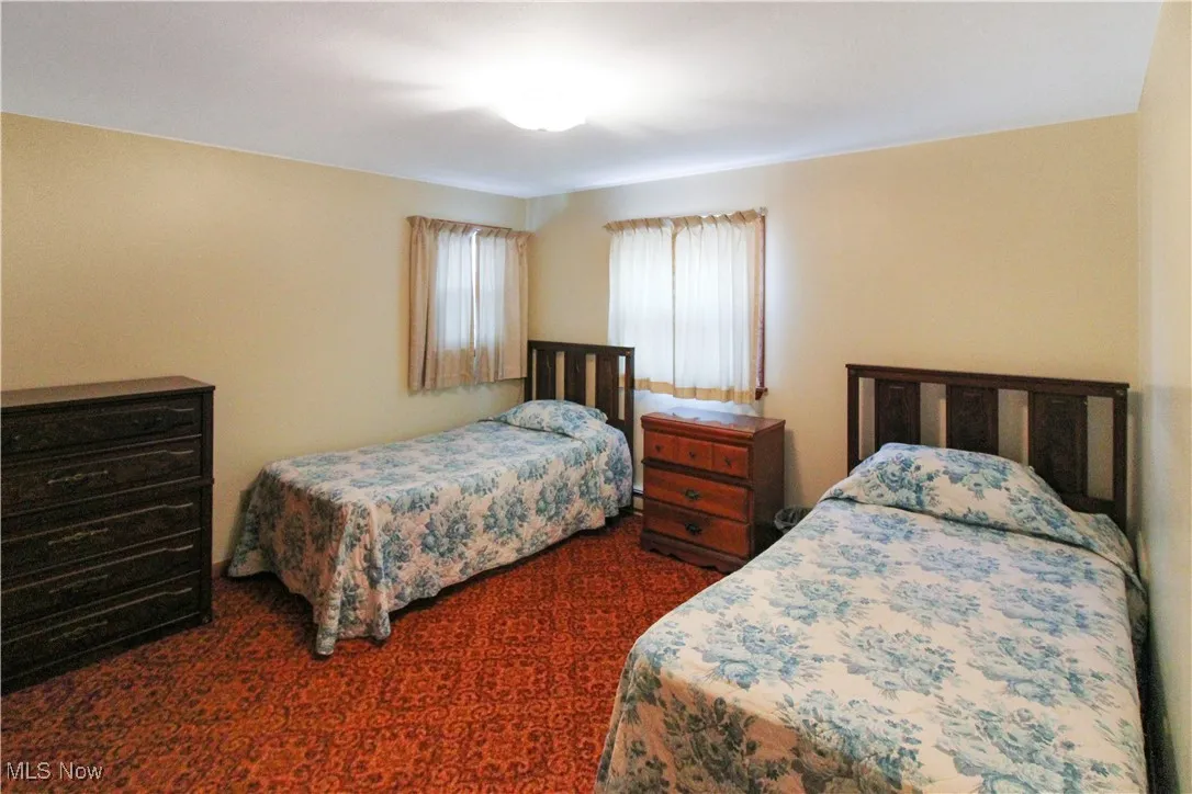 Bedroom featuring dark carpet