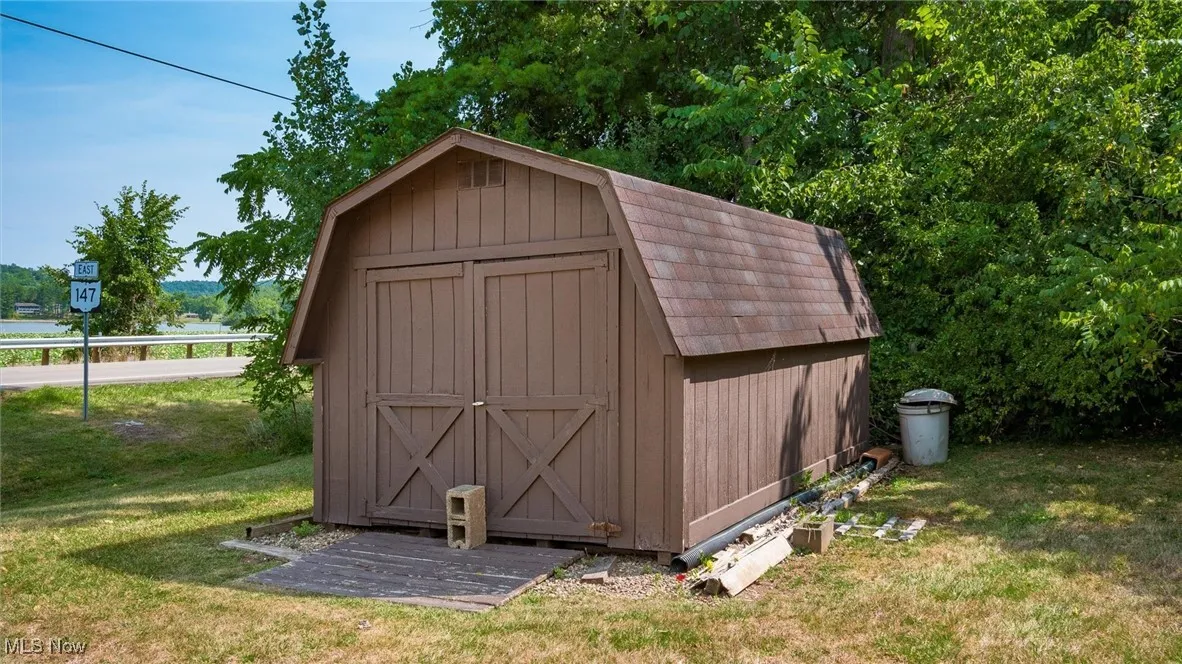 View of outdoor structure with a lawn