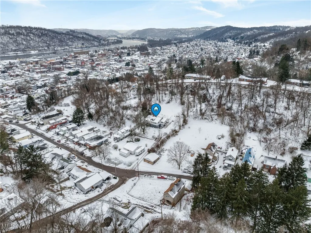 Snowy aerial view featuring a mountain view