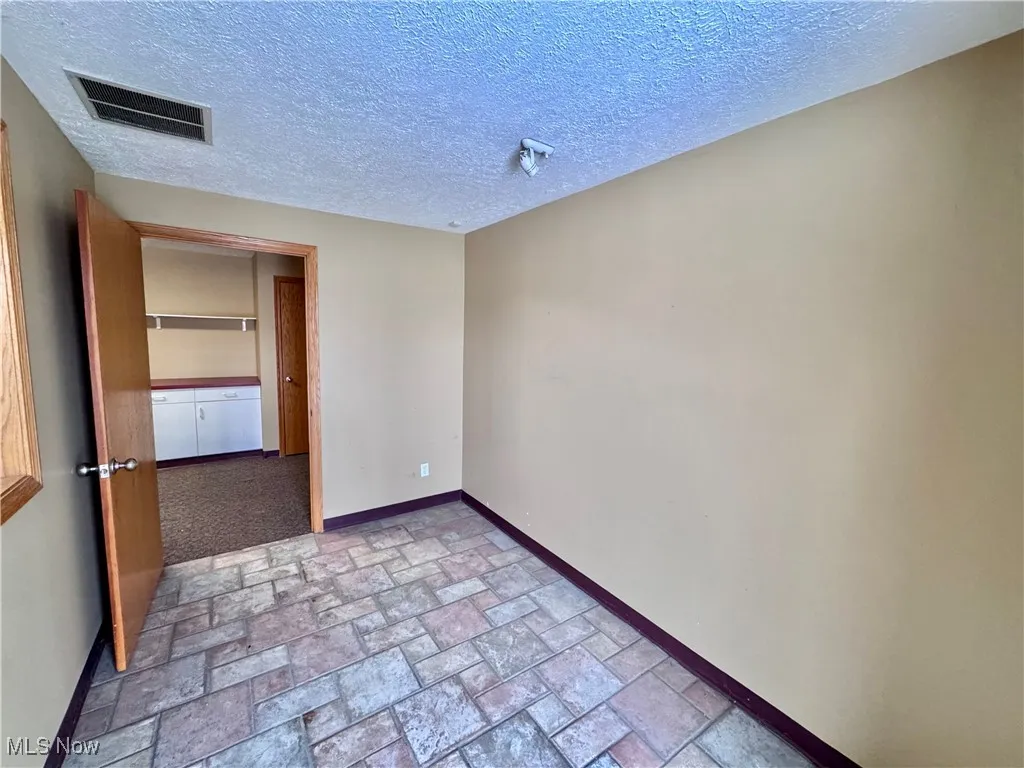 Spare room featuring a textured ceiling
