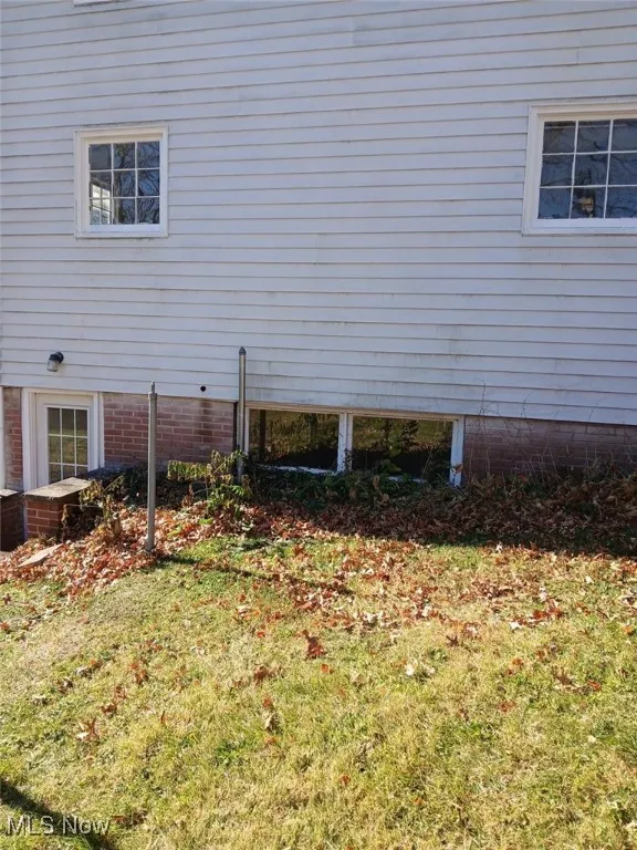 View of home's exterior with a lawn