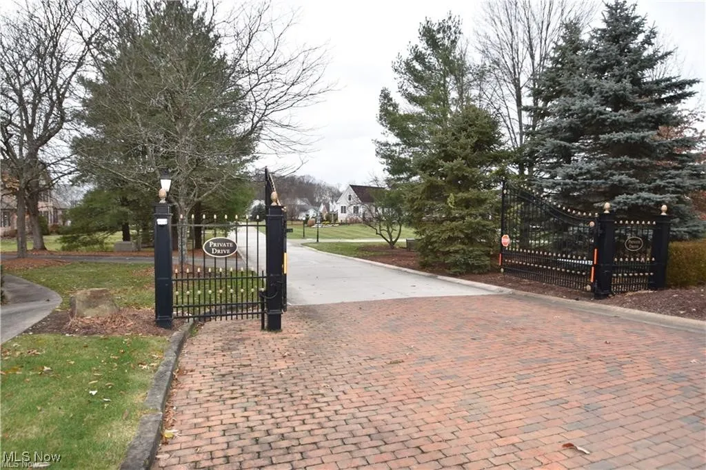 View of gate featuring a lawn
