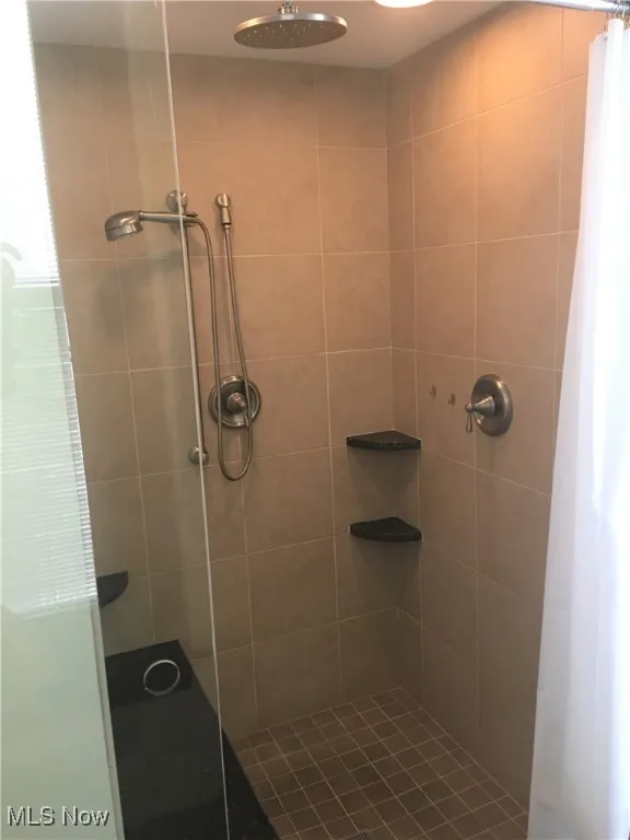Bathroom featuring a shower with curtain