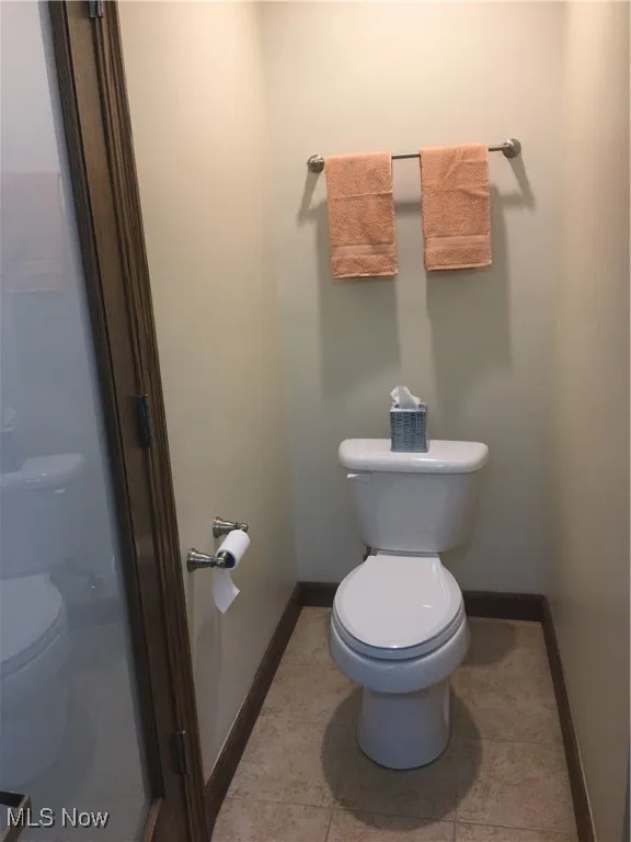 Bathroom with tile patterned floors and toilet