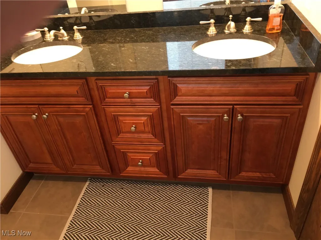 Bathroom with vanity and tile patterned flooring