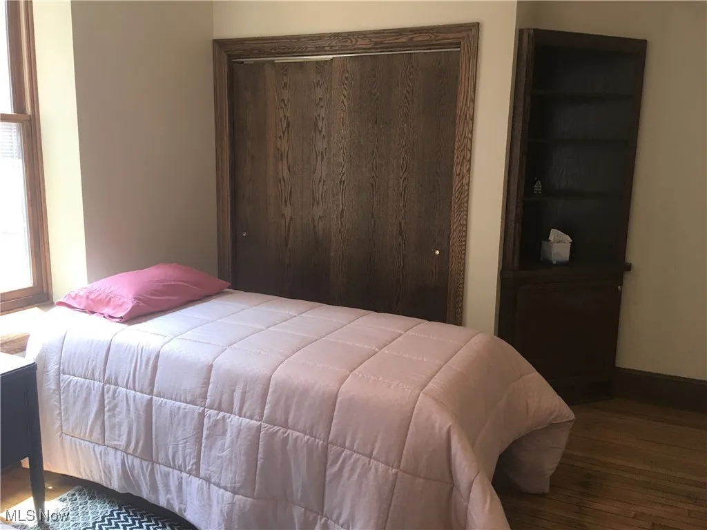 Bedroom featuring hardwood / wood-style flooring and a closet