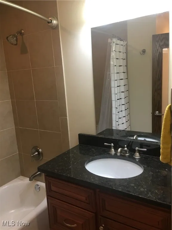 Bathroom featuring vanity and shower / bath combo