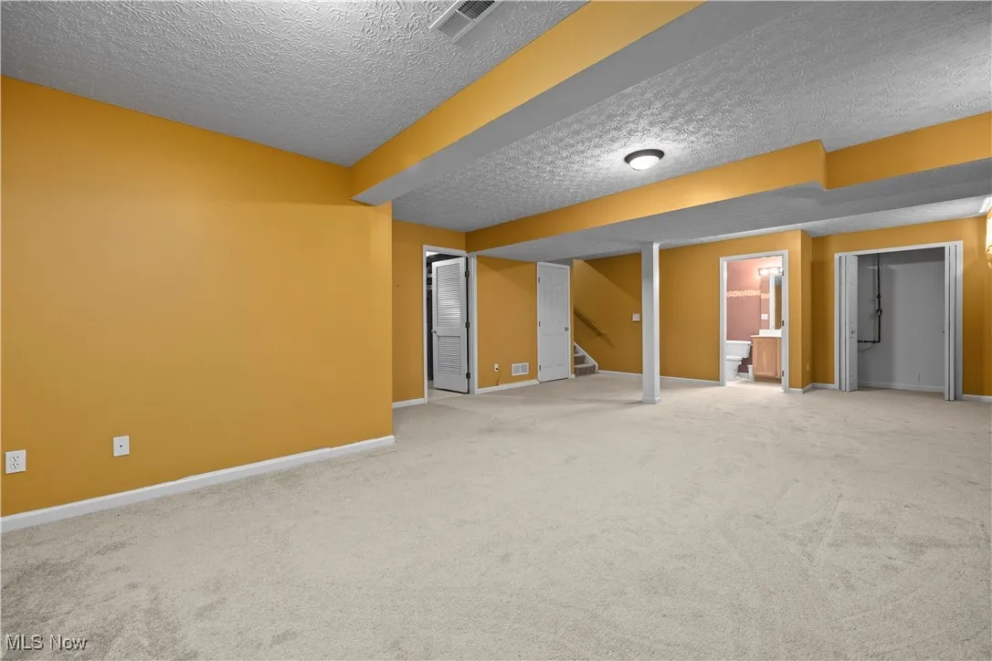 Basement featuring carpet floors and a textured ceiling