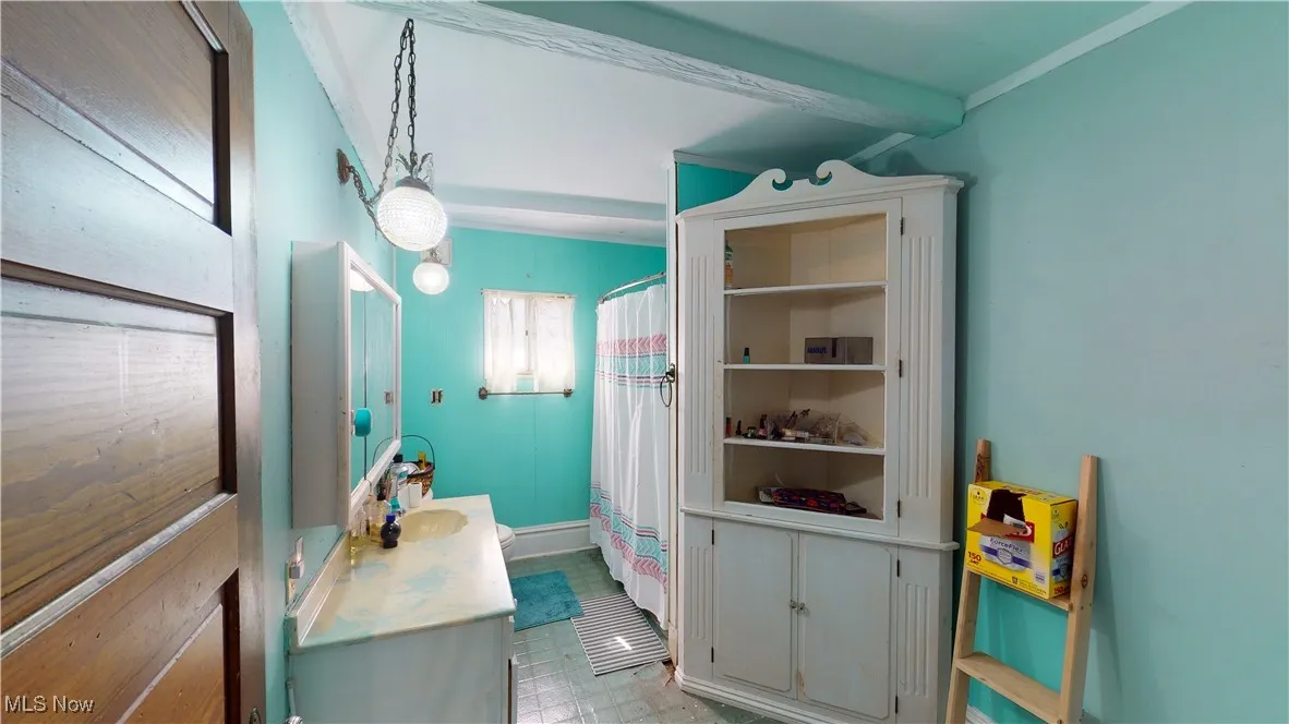 Bathroom with crown molding and vanity