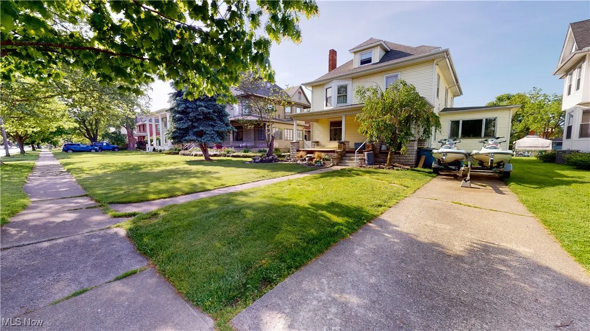 View of front of property with a front lawn and covered porch