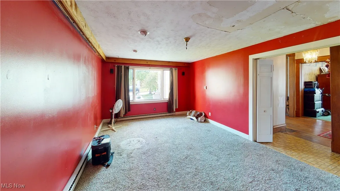 Carpeted spare room featuring a textured ceiling