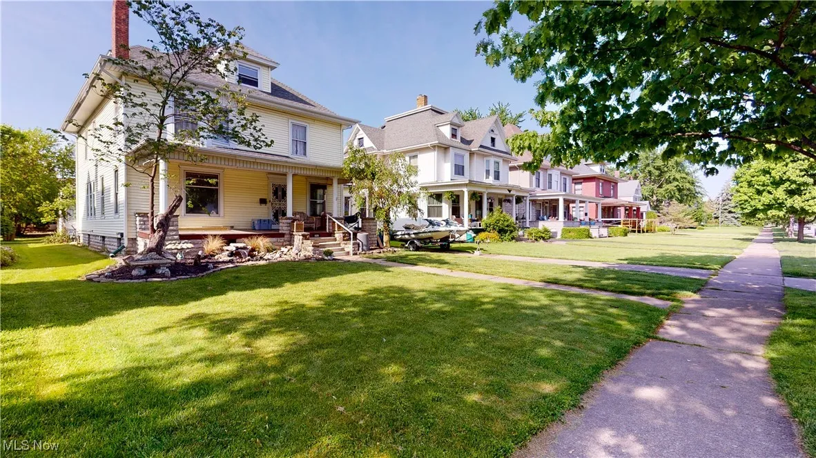 Victorian-style house with a porch and a front yard