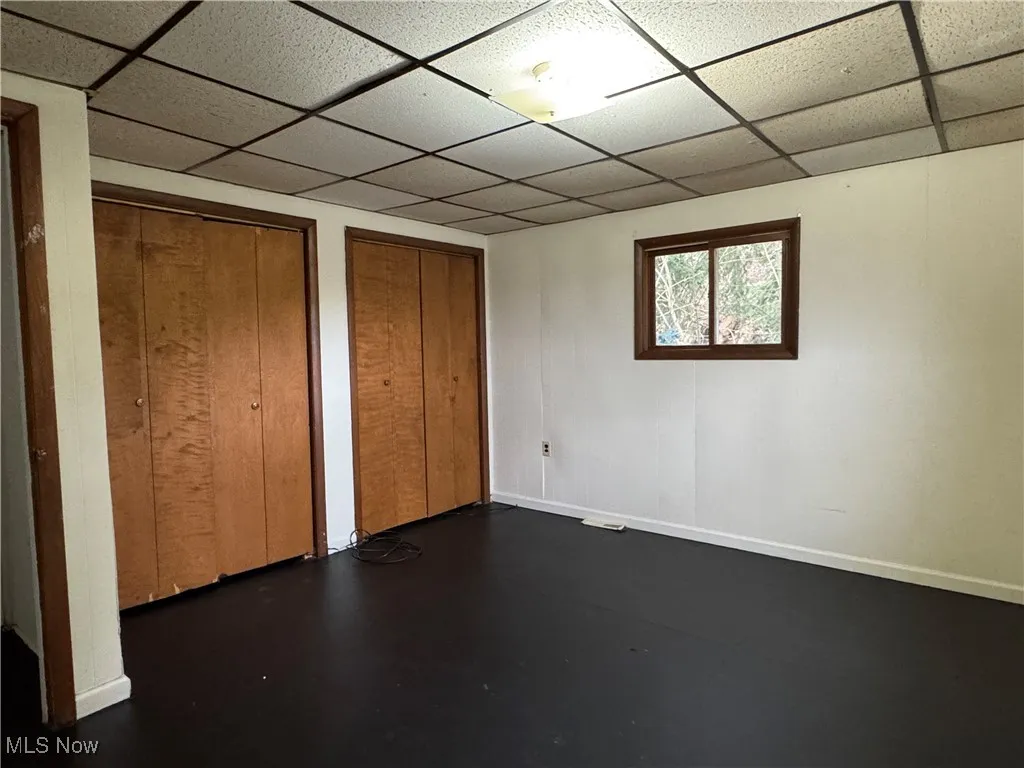 2nd floor Unfurnished bedroom featuring a drop ceiling and two closets