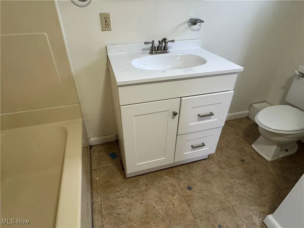 2nd floor Bathroom featuring vanity, a tub to relax in, tile patterned floors, and toilet