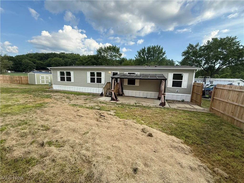 Back of property with a shed