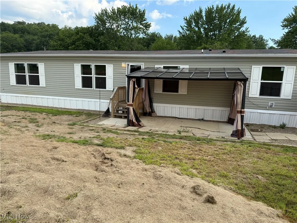 Rear view of house featuring a patio area