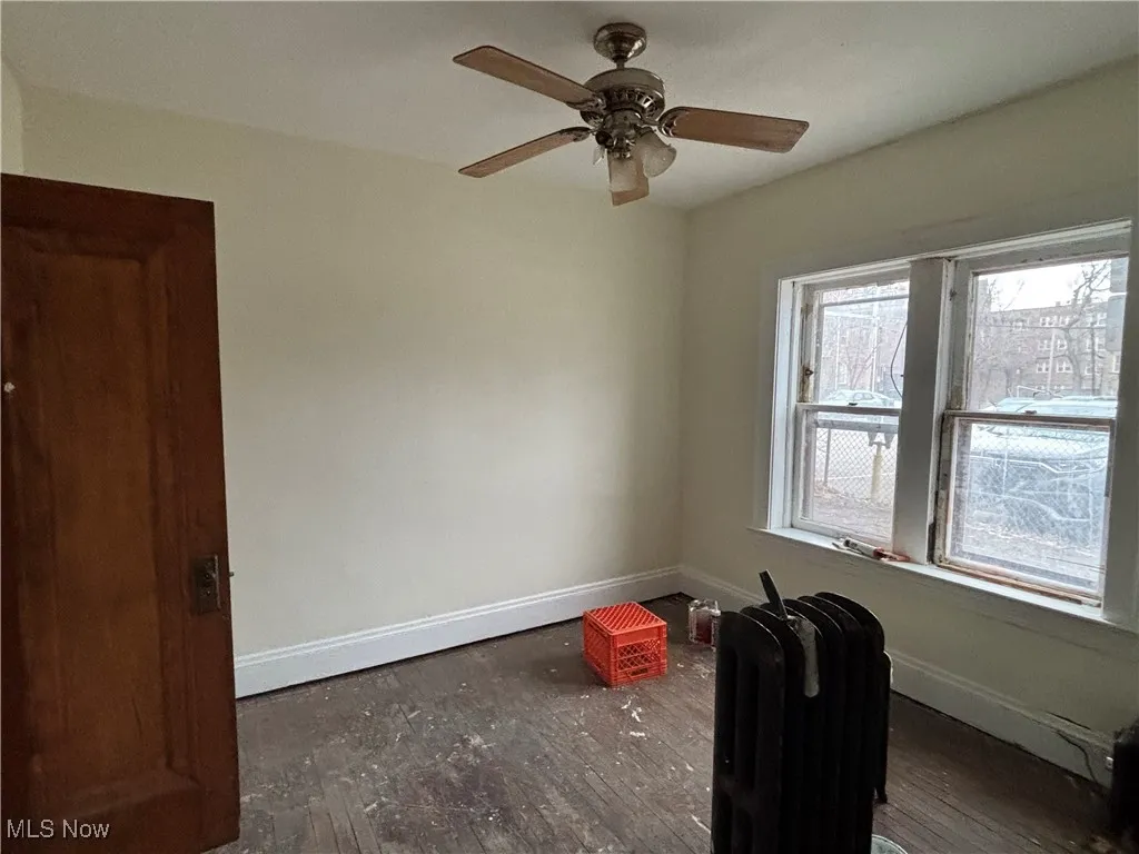 Spare room with ceiling fan and radiator