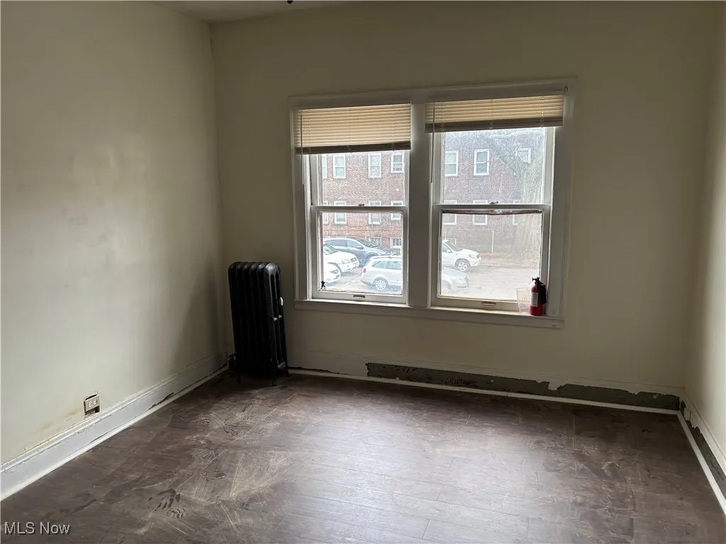 Empty room featuring radiator heating unit
