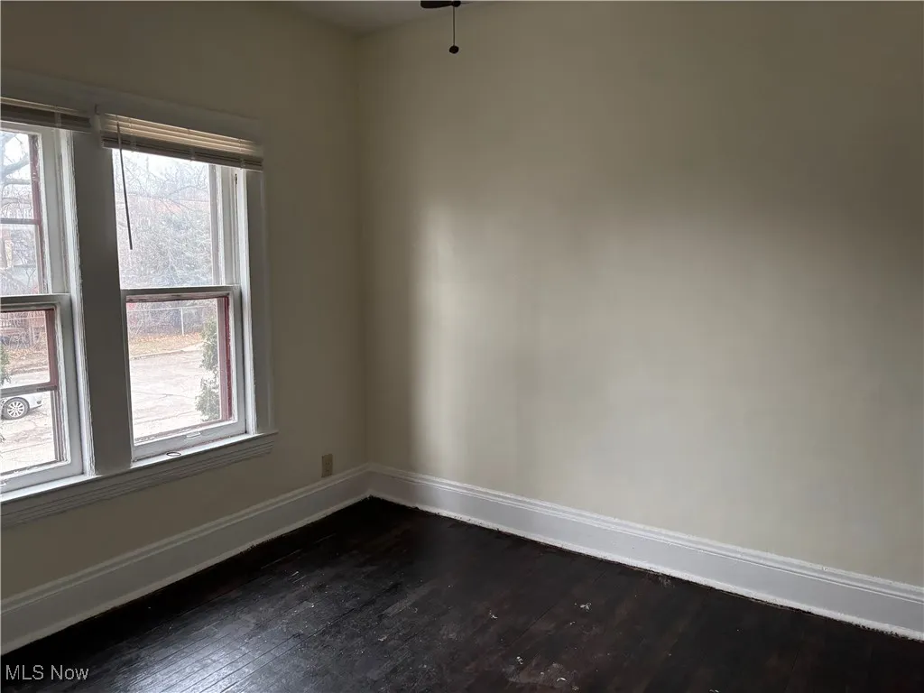 Unfurnished room with dark hardwood / wood-style flooring