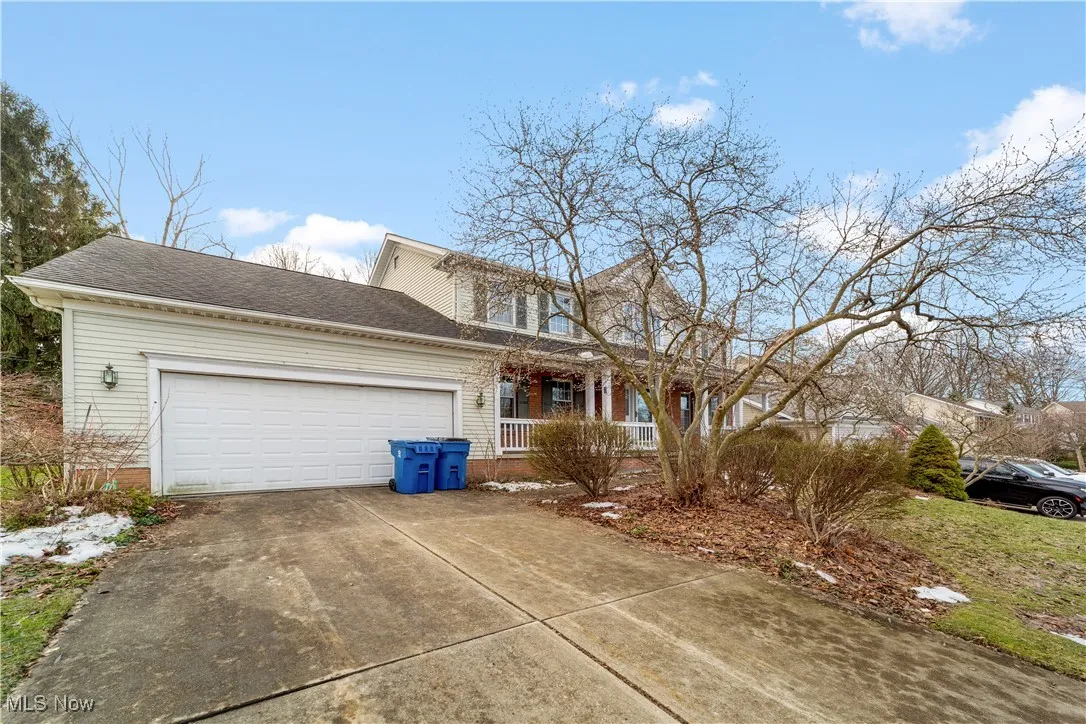 Exterior view with concrete drive, landscaping, and large 2 car garage