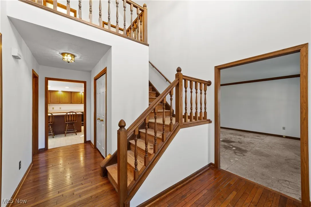 Two-Story Foyer with Wood Floors Open Stairwell