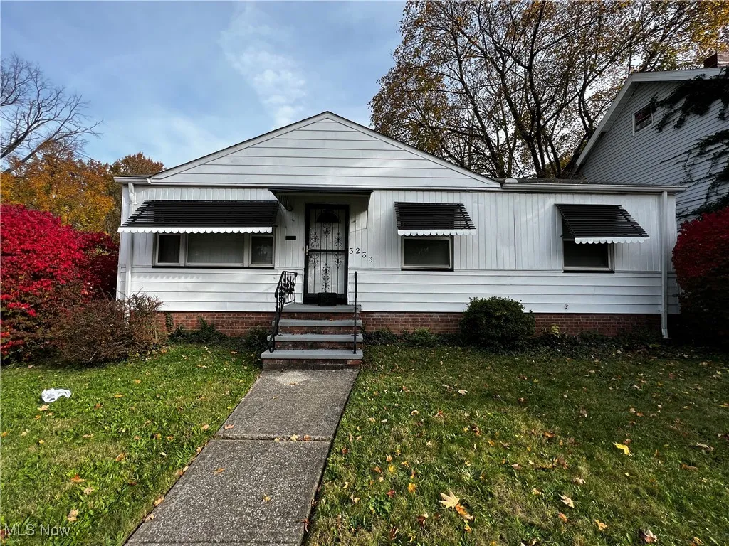 Bungalow-style home with a front lawn