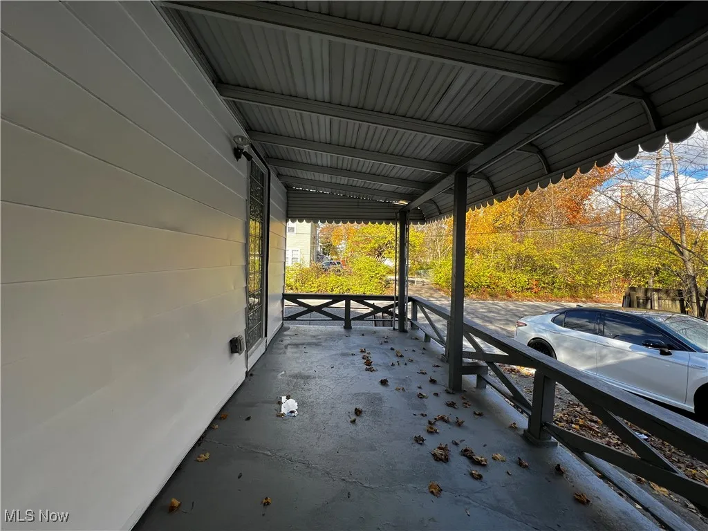 View of patio with a carport