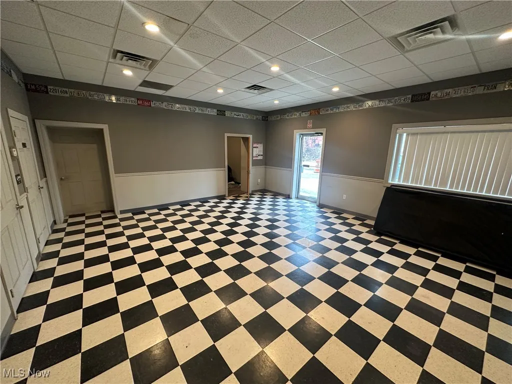 Unfurnished room featuring a drop ceiling