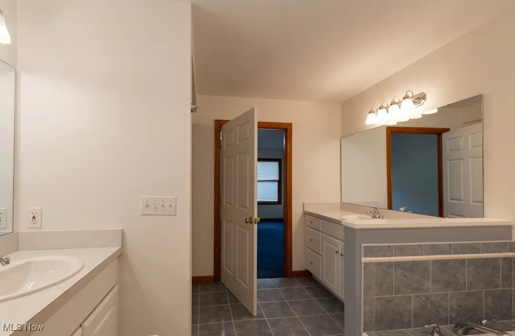Bathroom with tile patterned flooring and vanity