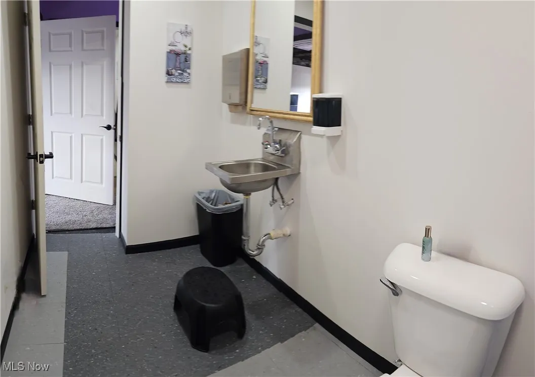 Bathroom featuring sink and toilet
