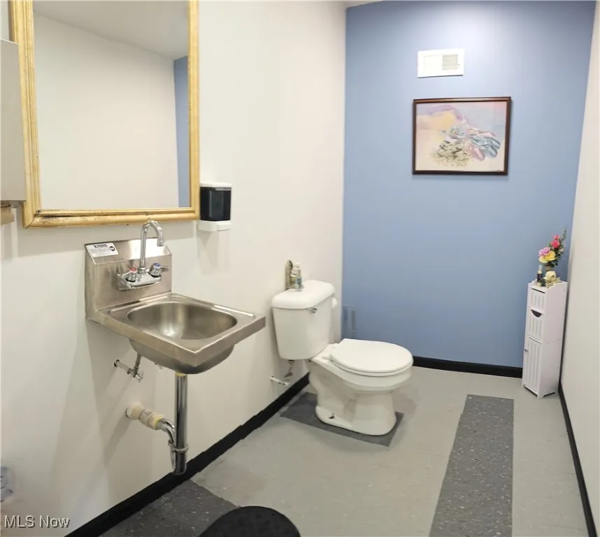 Bathroom featuring sink and toilet