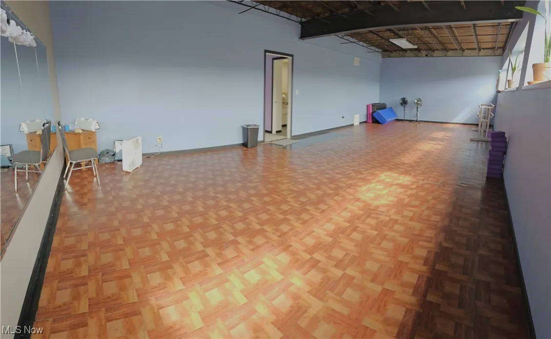 Empty room featuring a towering ceiling