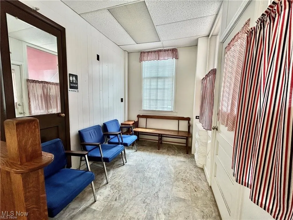 Living area featuring a paneled ceiling
