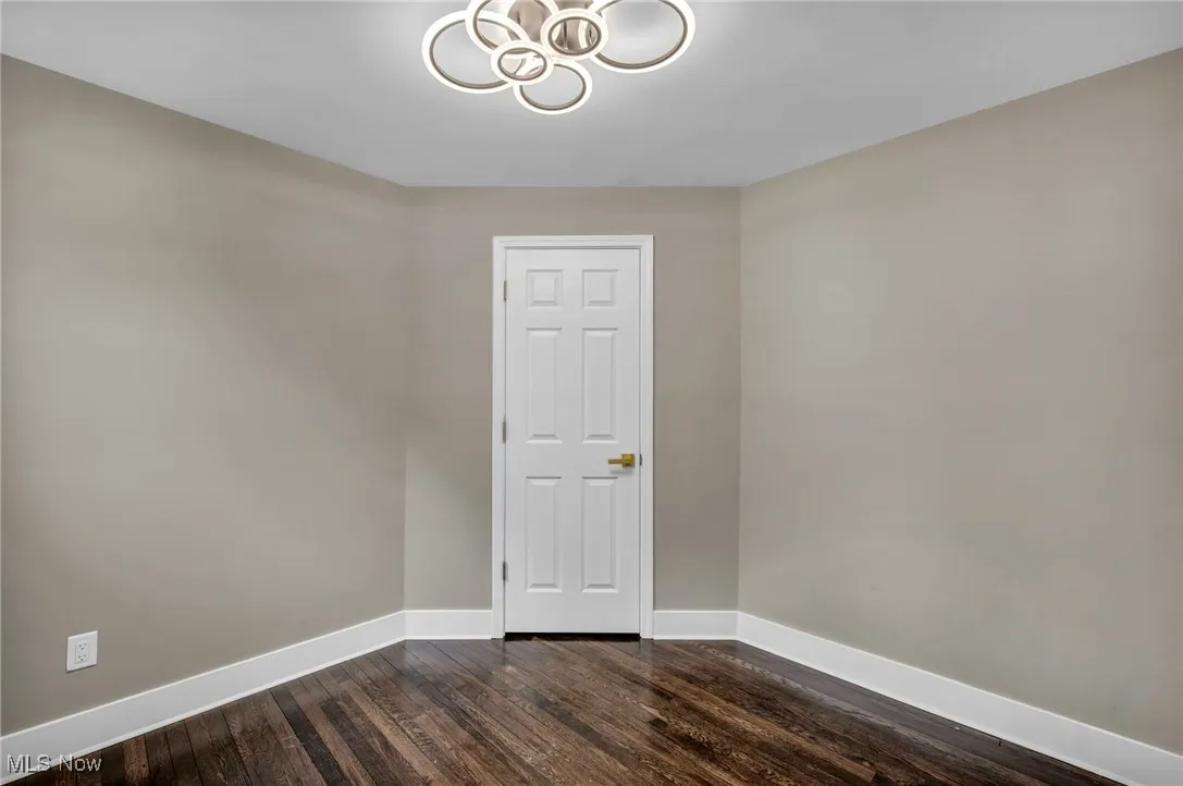 Unfurnished room featuring dark hardwood / wood-style flooring