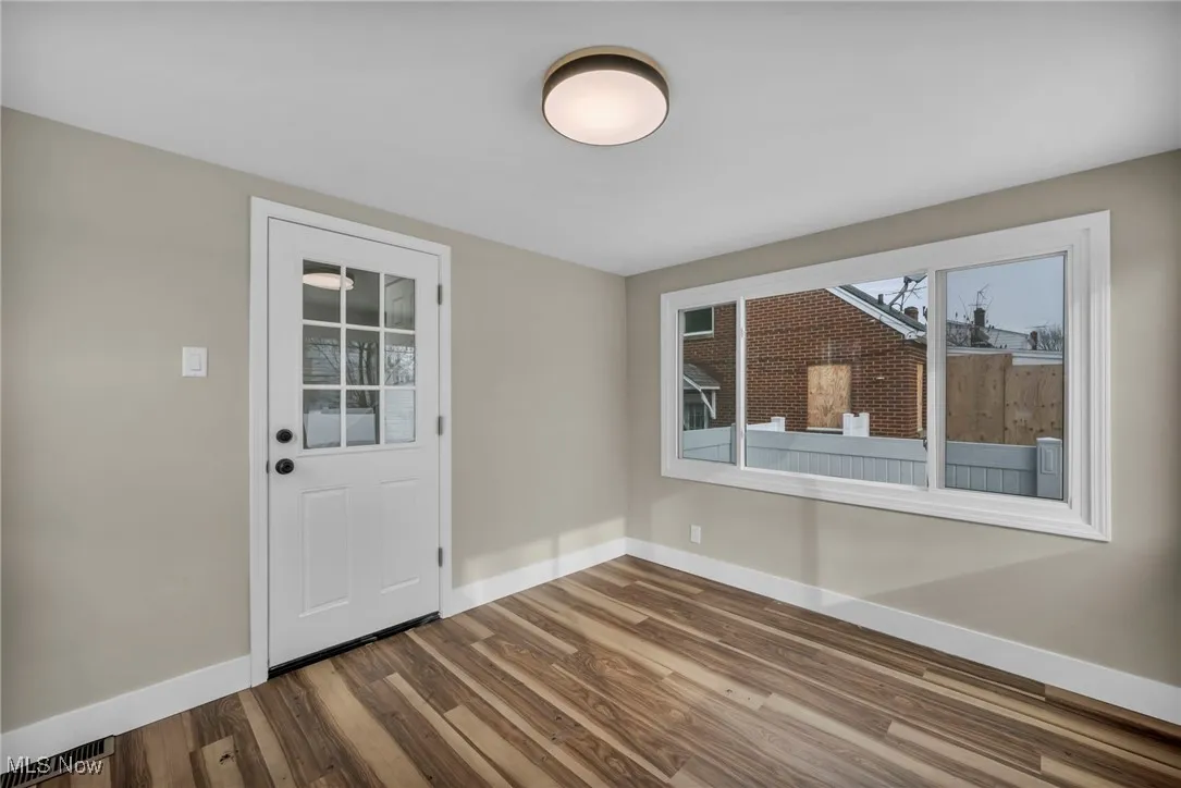 Foyer entrance with wood-type flooring