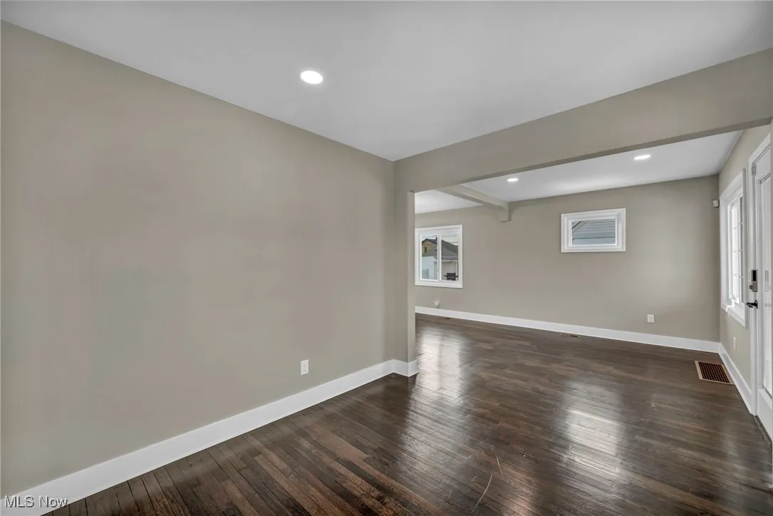 Unfurnished room featuring dark hardwood / wood-style flooring