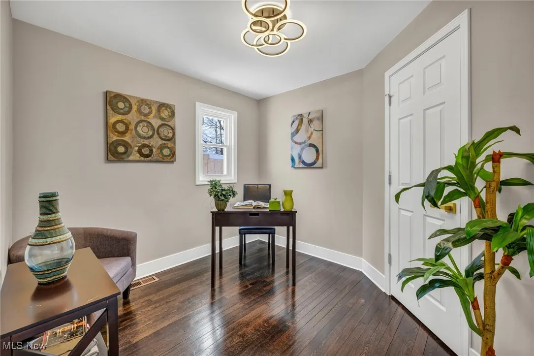 Office featuring visible vents, baseboards, and dark wood finished floors