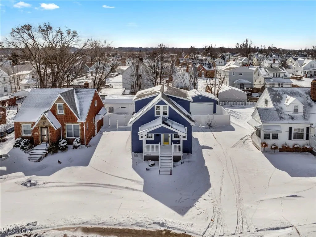 Snowy aerial view with a residential view