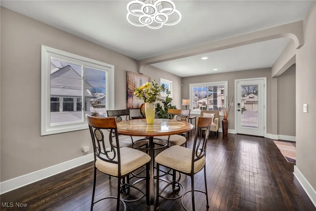 Dining room featuring recessed lighting, baseboards, a notable chandelier, and hardwood / wood-style floors
