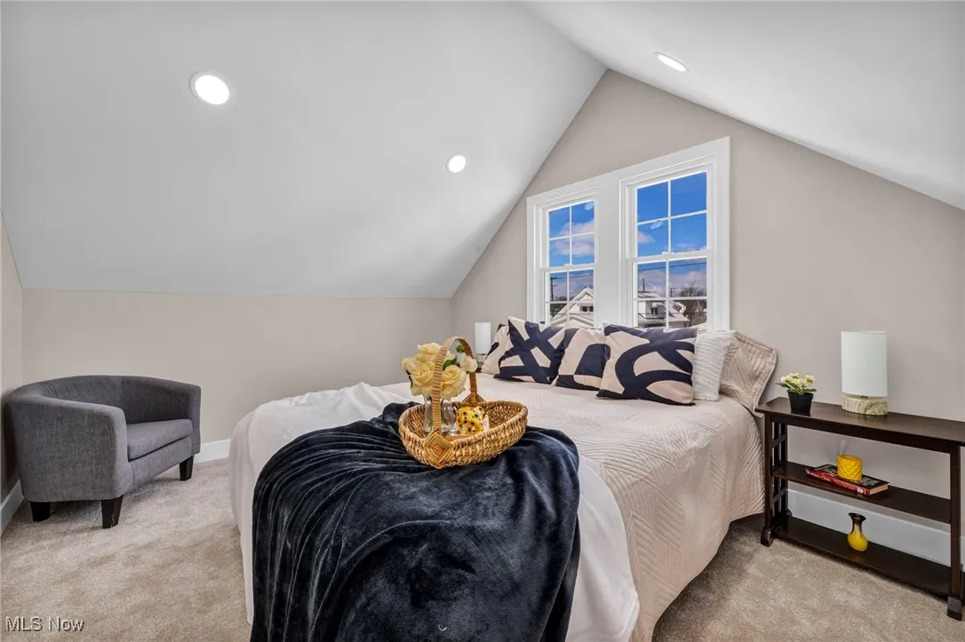 Carpeted bedroom featuring recessed lighting, baseboards, and vaulted ceiling