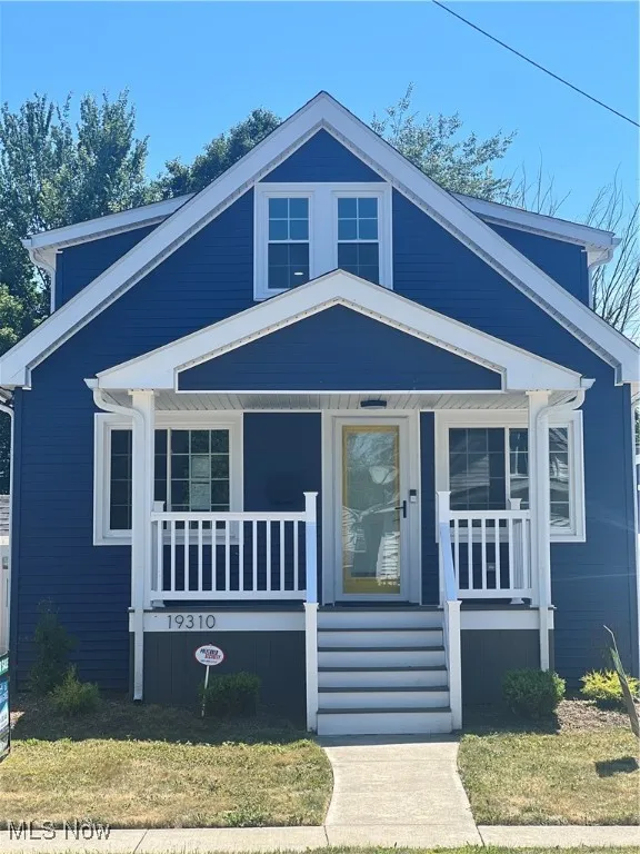 View of front of house featuring a porch and a front lawn