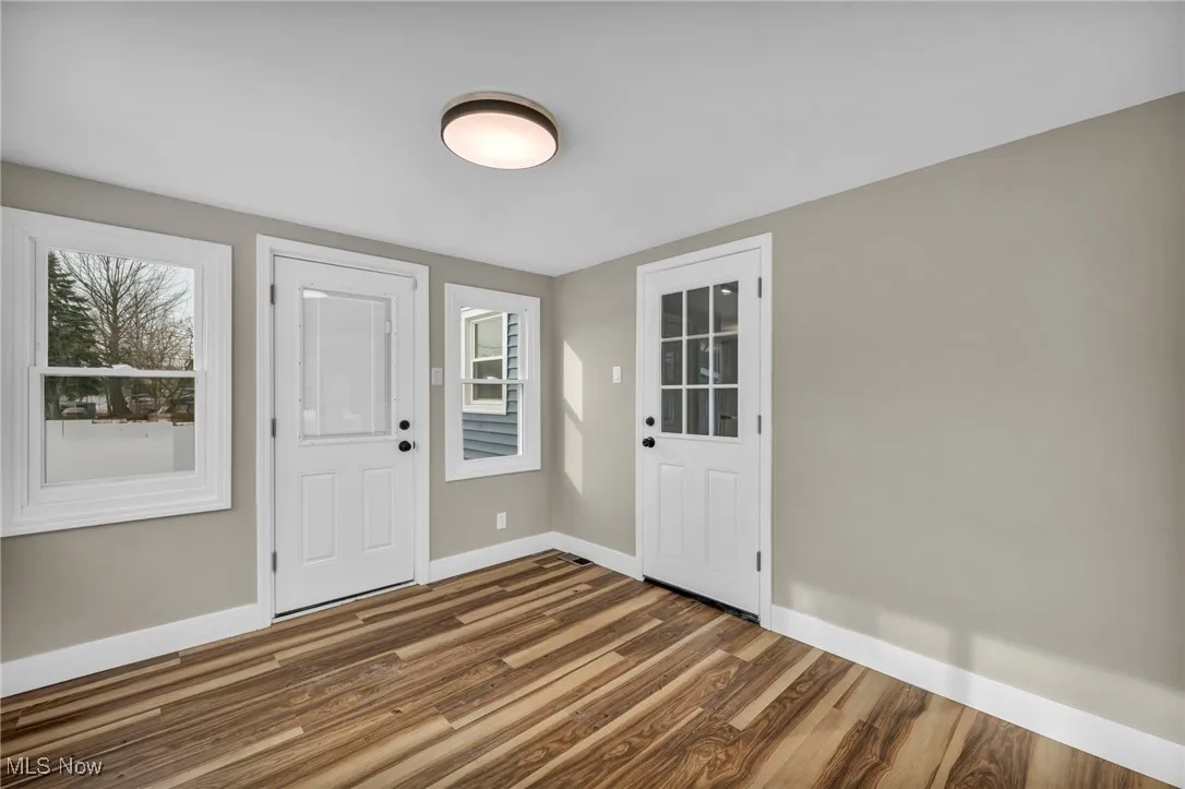 Entrance foyer with dark hardwood / wood-style flooring