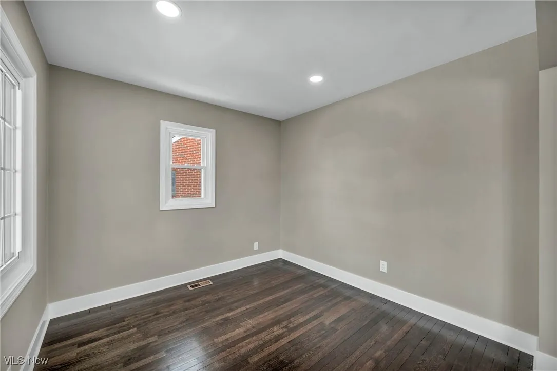 Spare room with dark hardwood / wood-style floors