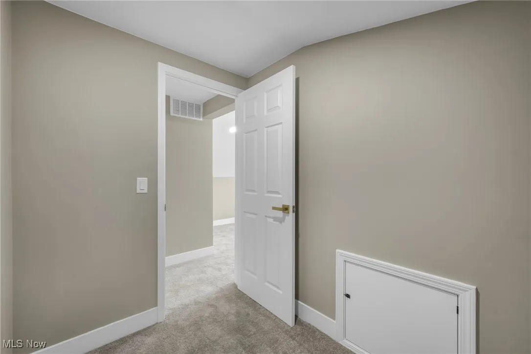 Hallway with light colored carpet
