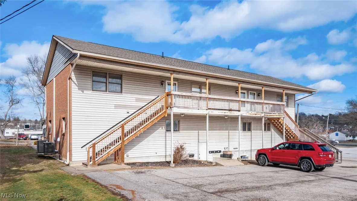 Rear view of property with cooling unit and covered porch