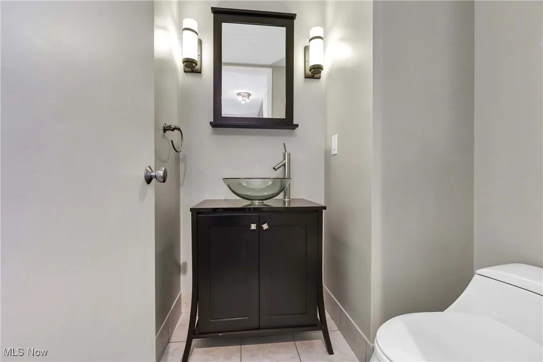 Bathroom with vanity, tile patterned floors, and toilet
