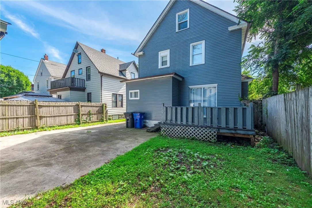 Back of property with a deck and a fenced backyard