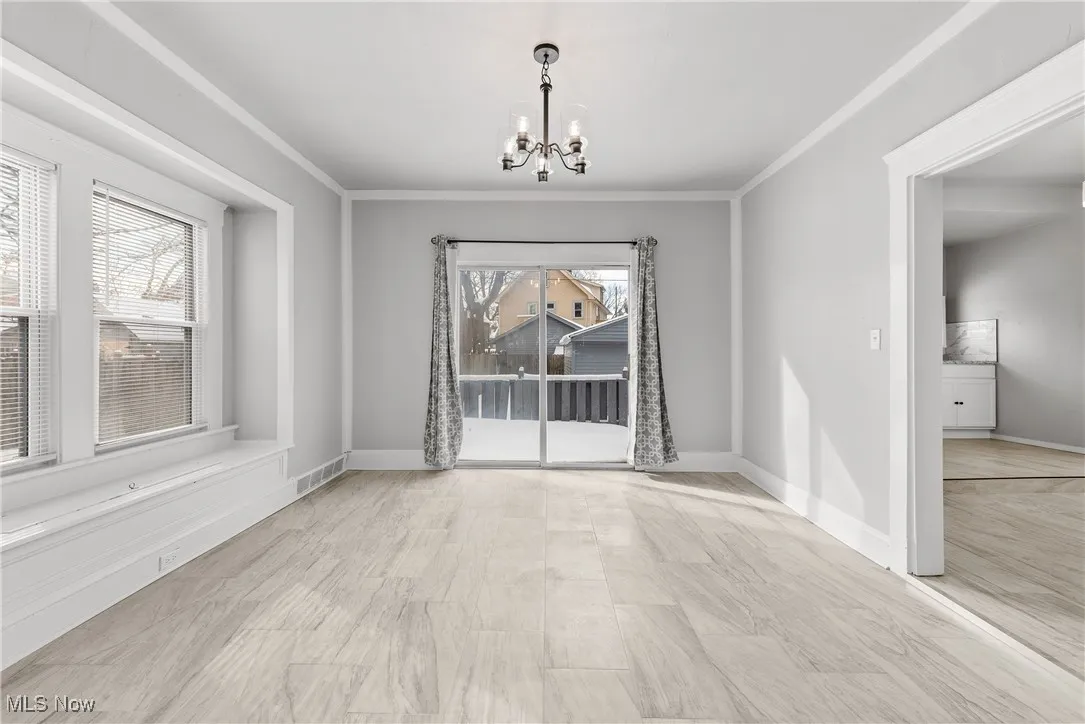 Unfurnished dining area featuring ornamental molding and an inviting chandelier